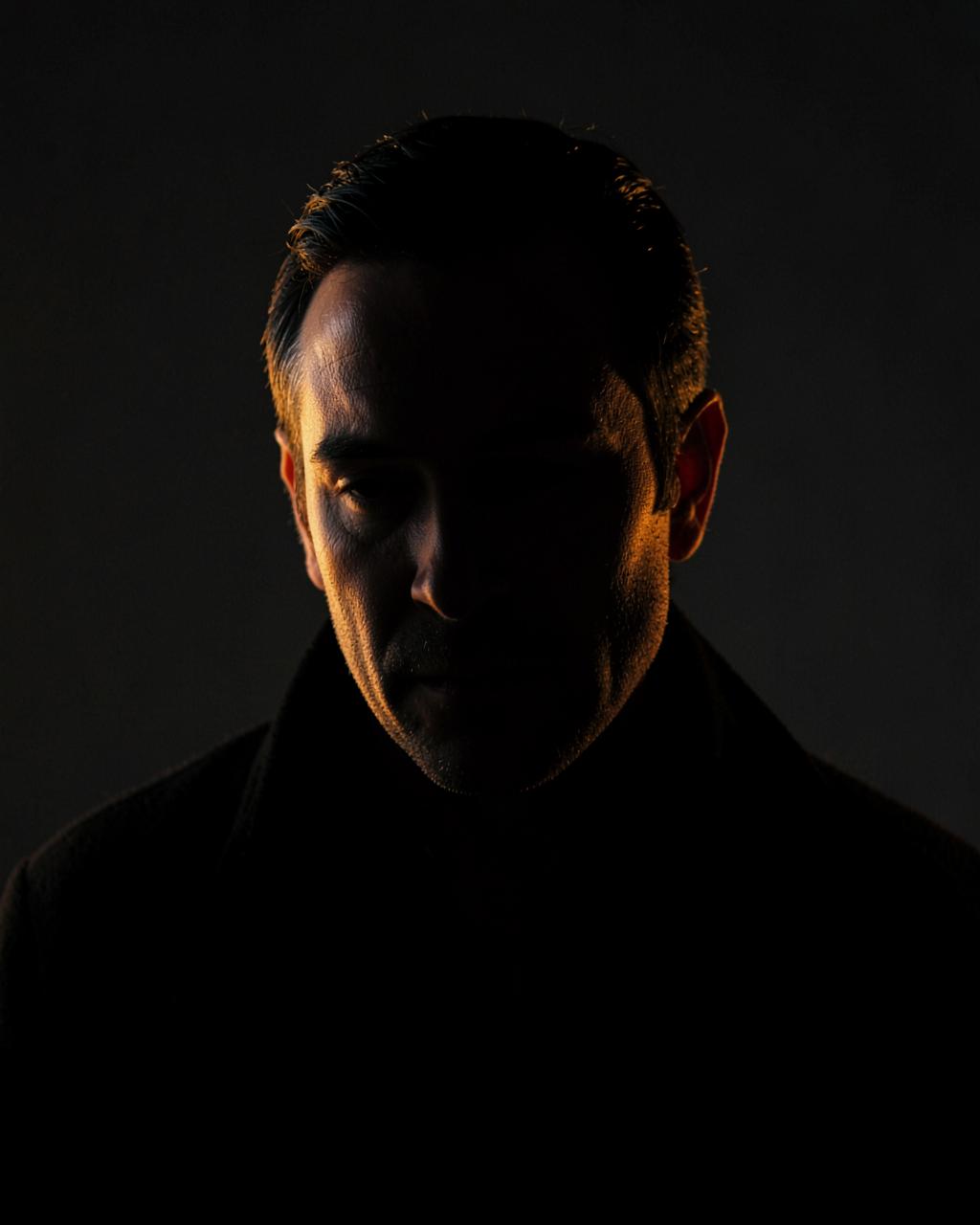 Portrait of the IHNM Films producer in warm, low-key light