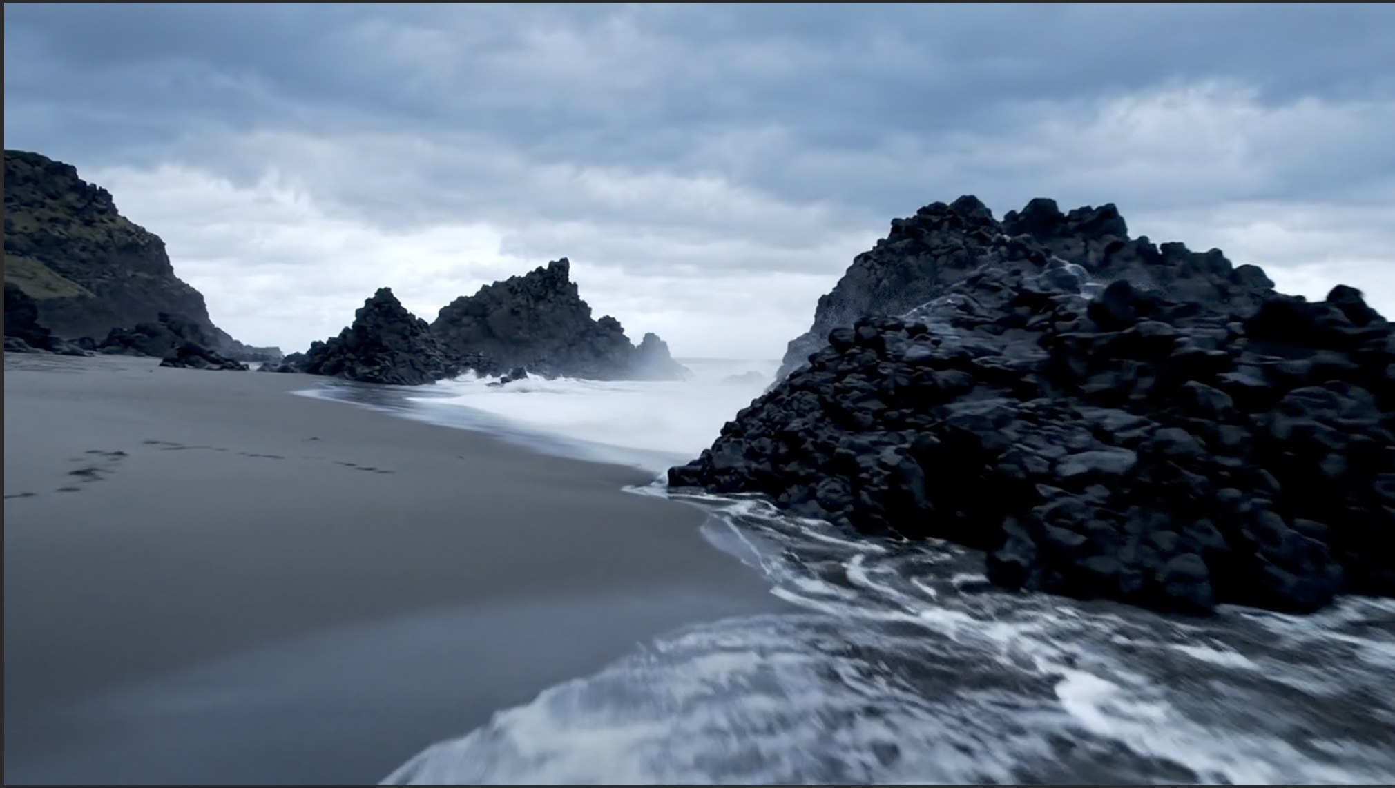 Waves break over black volcanic rocks on a desolate shoreline under a stormy sky